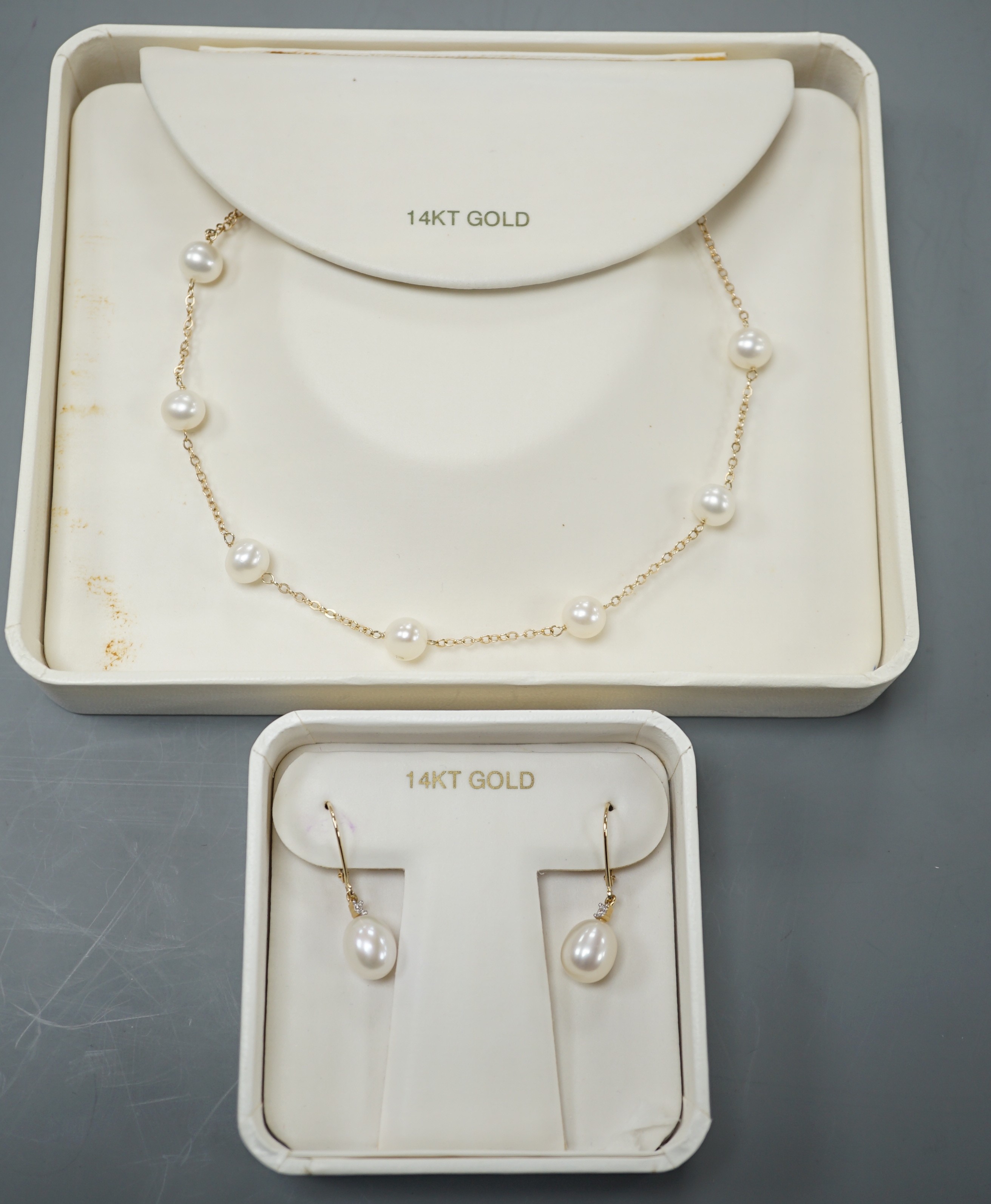 A boxed modern 14k and cultured pearl set necklace, 40cm and a pair of matching earrings.